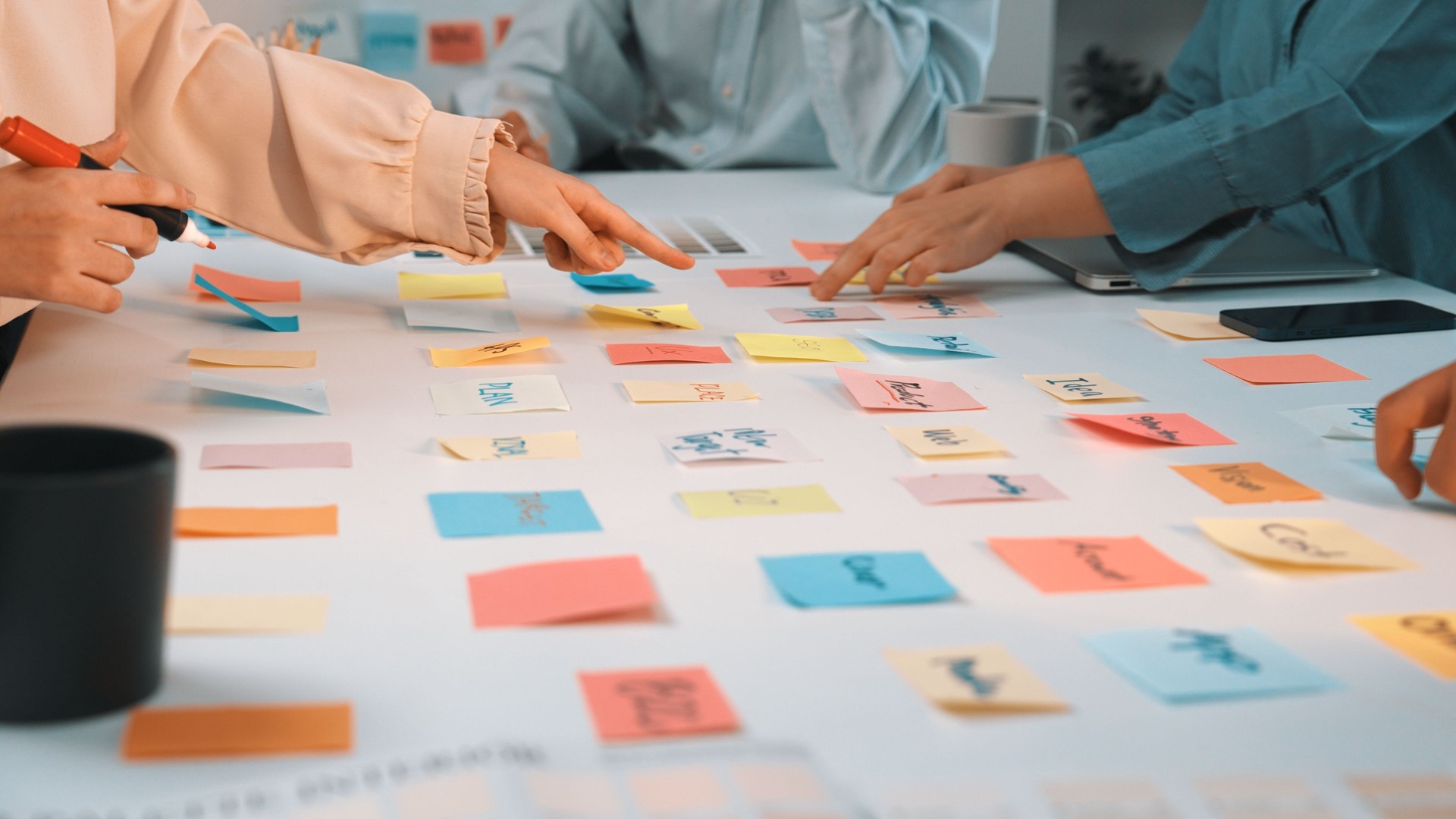 Collaborative Teamwork with Colorful Sticky Notes on White Table for Brainstorming Creative Ideas in Modern Office SACTR